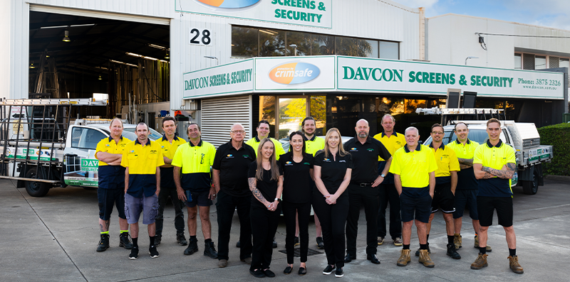 Davcon team standing together in front of the Crimsafe factory