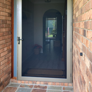 Crimsafe Ultimate front door installed by Davcon in the colour Champagne