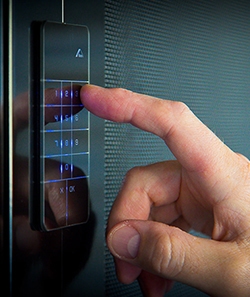 man using a security touch screen to open crimsafe iQ doors